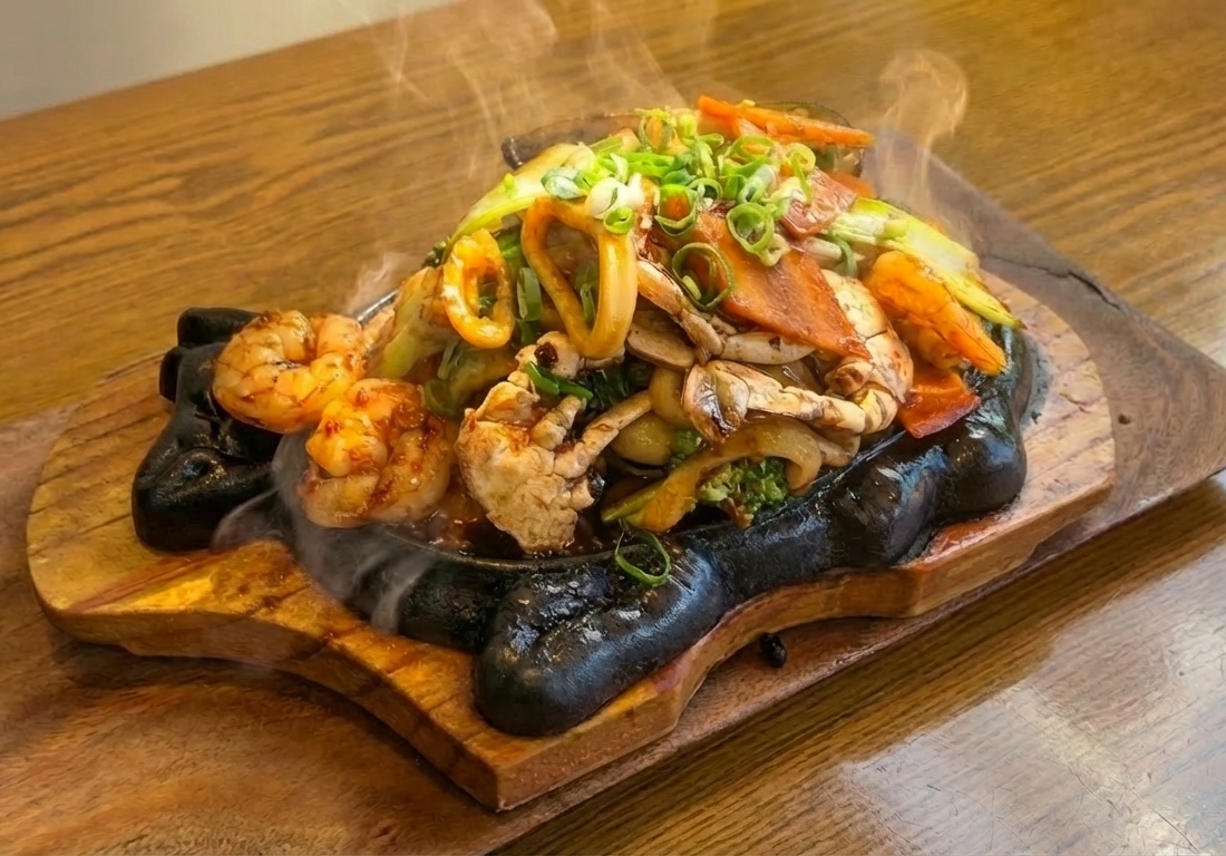 Sizzling Black Bean Plate on cast iron with steam rising — Korean-Vietnamese fusion with Hung Cheong salted black beans, Pho Heaven Westgate